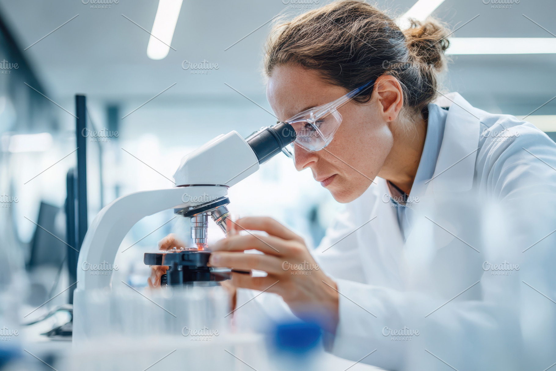 Scientist working with a microscope in laboratory, a Health & Medical Photo by AlyaAnd