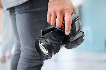 Digital photography, camera and hands of photographer in studio shooting creative memory picture, photoshoot or production. Lens, art creativity or man with professional dslr for artistic vision shot, a Photo by Peopleimages.com