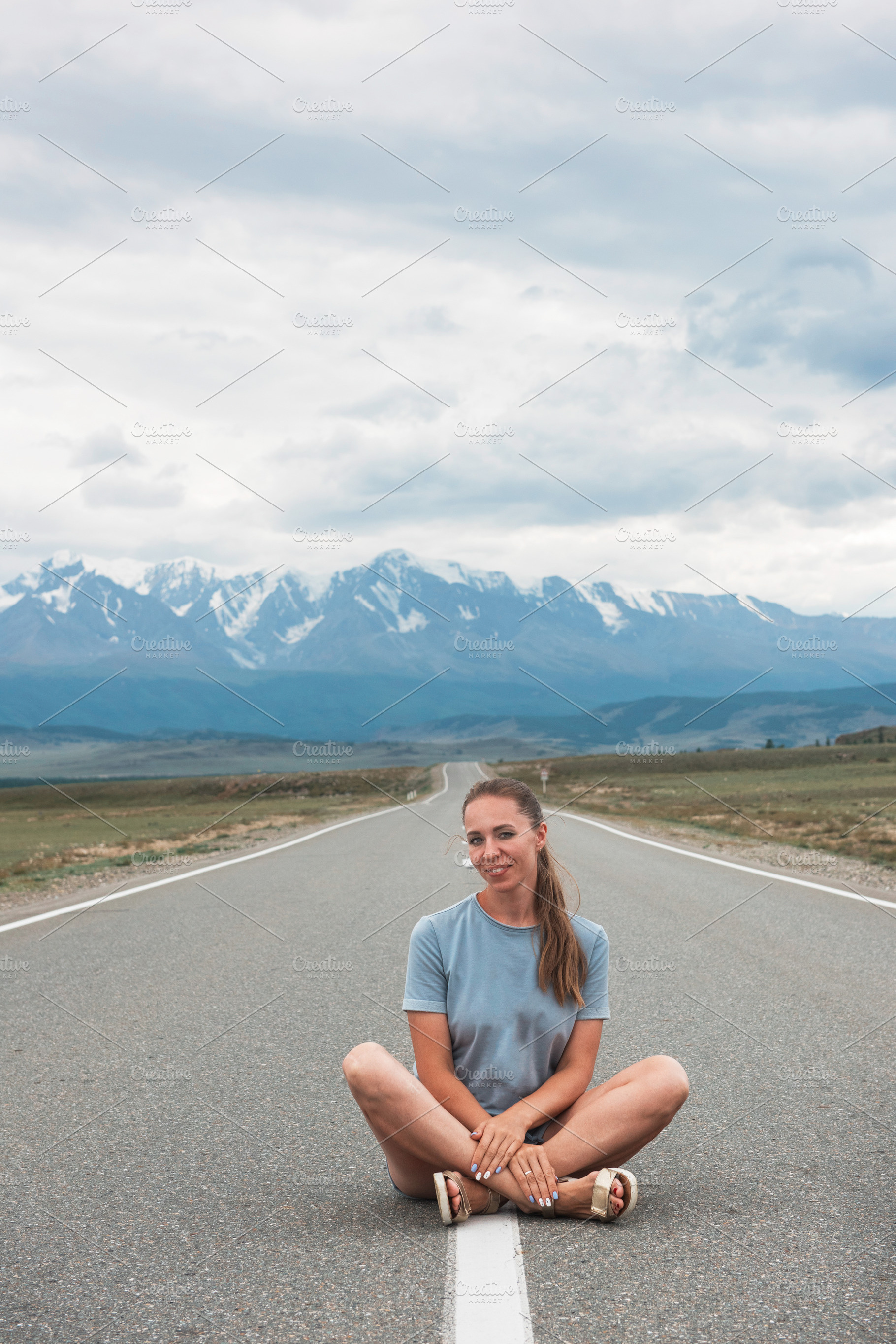 Woman sitting on the road featuring daydreaming, woman, and beautiful, a Person Photo by Jan Jack Russo Media