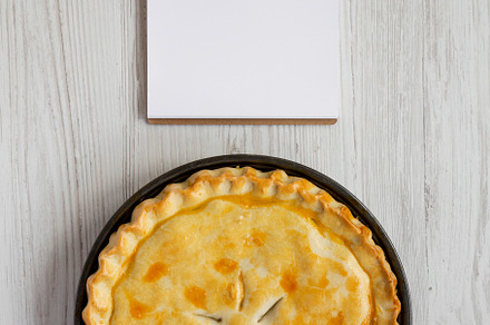 A Piece of Chicken Pot Pie, blank notepad on a white wooden back, a Food & Drink Photo by LiudmylaChuhunova