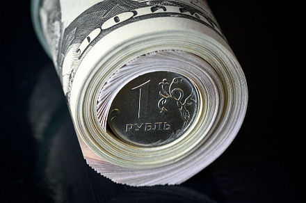 Russian ruble coin in dollars roll, a Business Photo by Lopatin Photo