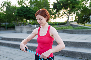 Young woman doing exercise outdoors, a Graphic by HalfPoint