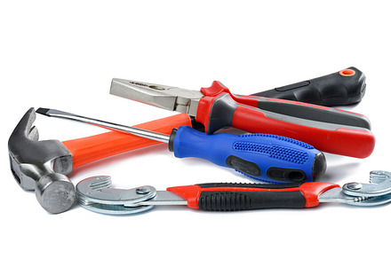 Screwdriver, wrench, pliers and hammer isolated on white backgro, an Industrial Photo by ndanko