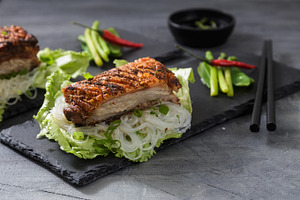 Oriental Roast Pork Belly with crispy skin with greens and noodles