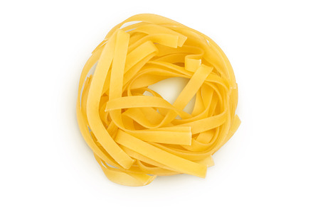 Raw tagliatelle pasta isolated on, a Food & Drink Photo by NataPhoto
