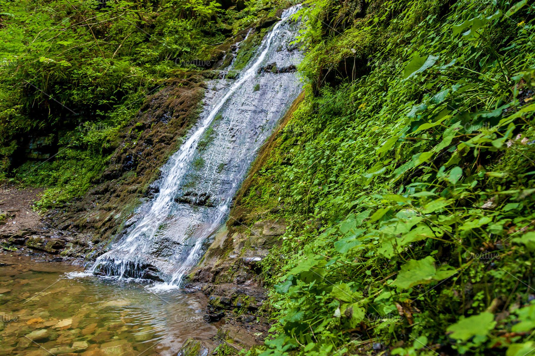 Forest waterfalls in the mountains, a Nature Photo by Photostock