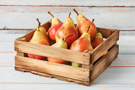 Red pears in crate on wooden table, a Food & Drink Photo by AlyaAnd