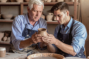 Senior Potter Teaching Young Apprentice in Studio, an Arts & Entertainment Photo by Davizro's Market