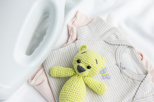 Detergent bottle, baby clothes, and toy bear for childcare, an Industrial Photo by Olena Rudo