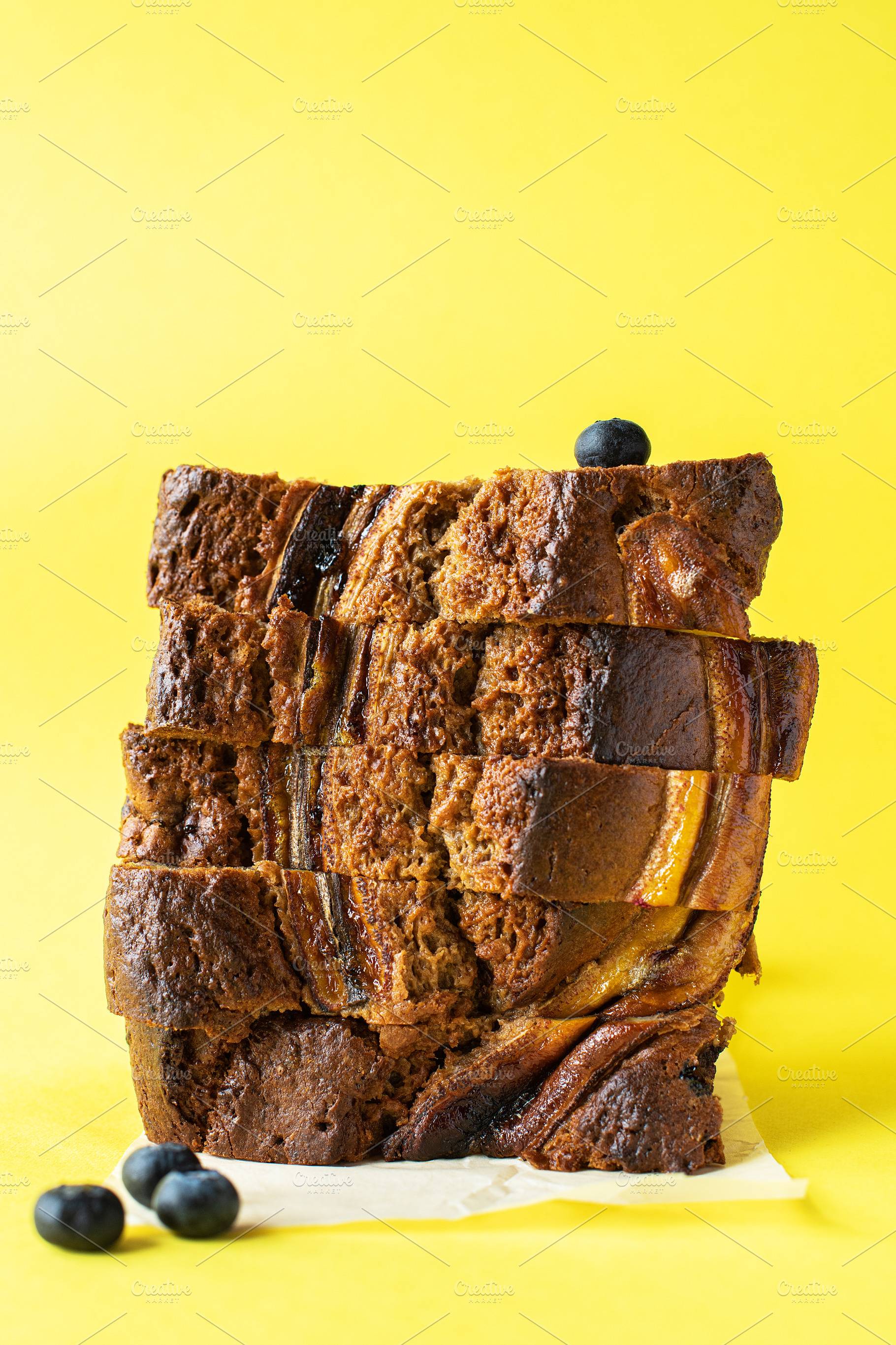 Sliced banana bread with blueberries, a Food & Drink Photo by Galiyah Assan