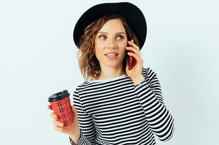 Fashionable young woman wearing black hat and striped shirt talk, a Person Photo by progressman
