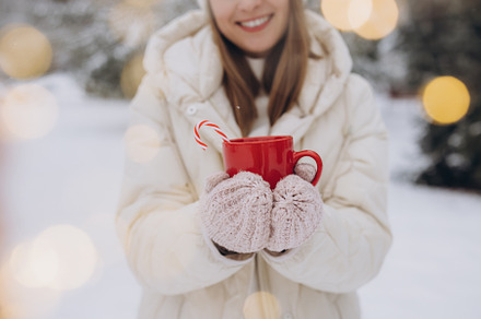 Cute happy woman holding hot coffee, a Holiday Photo by Cherkas Photography