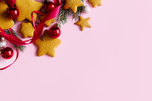 Christmas background with star gingerbread cookies, red baubles, a Photo by Sonjachni