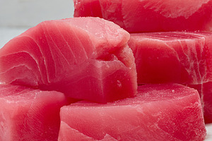 A stack of raw tuna pieces on a white board, a Food & Drink Photo by ndanko