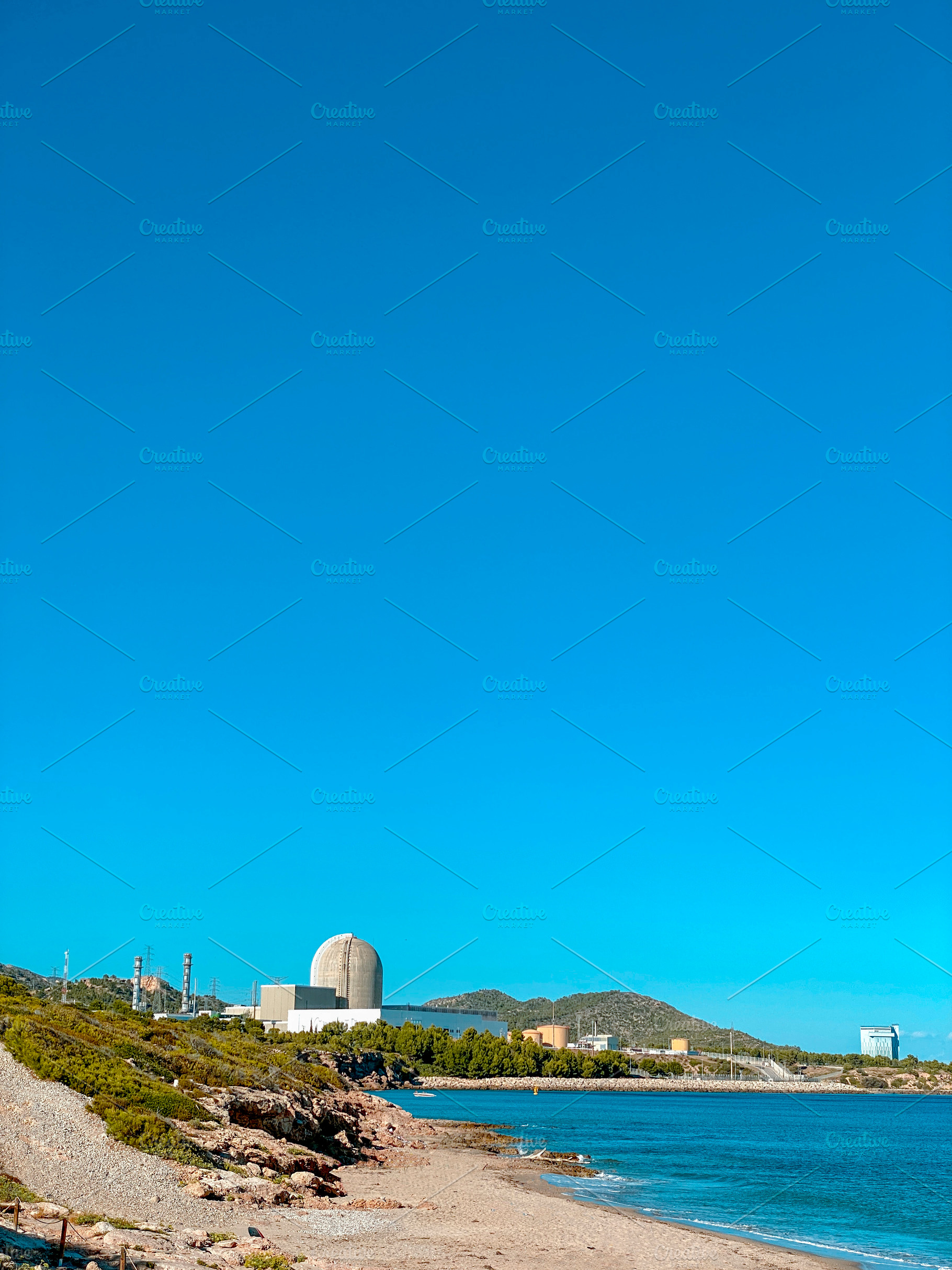 nuclear plant seen from La Almadrava beach, Spain, a Photo by Nito