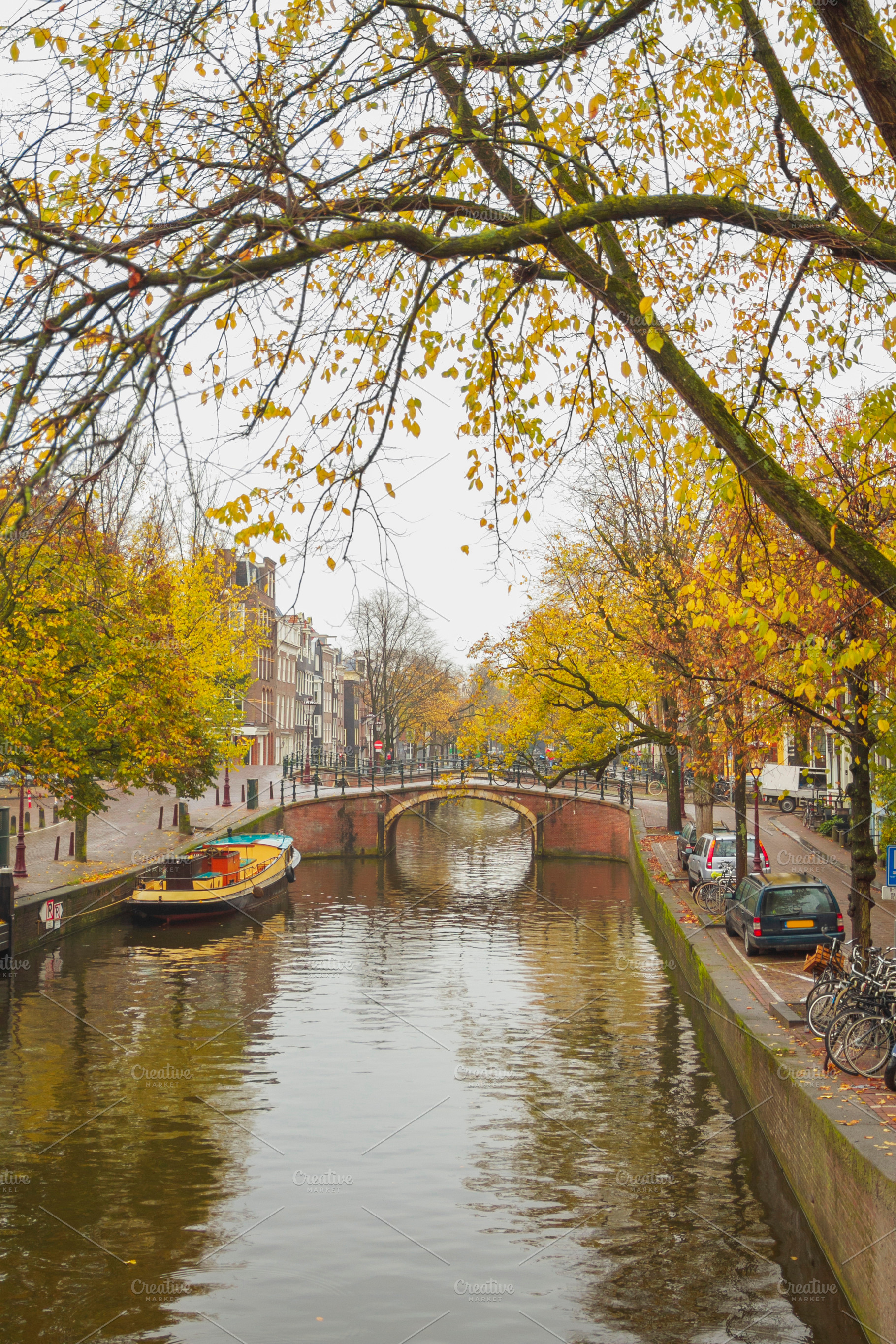 Historic arch bridge over autumn canal in Amsterdam, vertical tr, a Photo by Pictures for you!!!!!!!!!