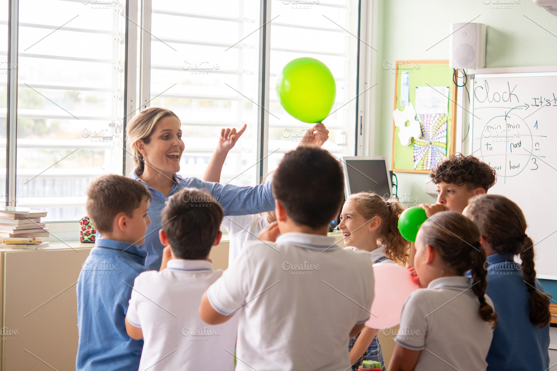 Elementary School Teacher Leading Interactive Classroom Activity with Balloons, a School & Education Photo by etorres69