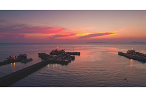 Ferry leaving pier at sunset, a Transportation Photo by Goinyk
