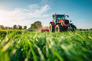 Tractor working in a green field, an Industrial Photo by AlyaAnd