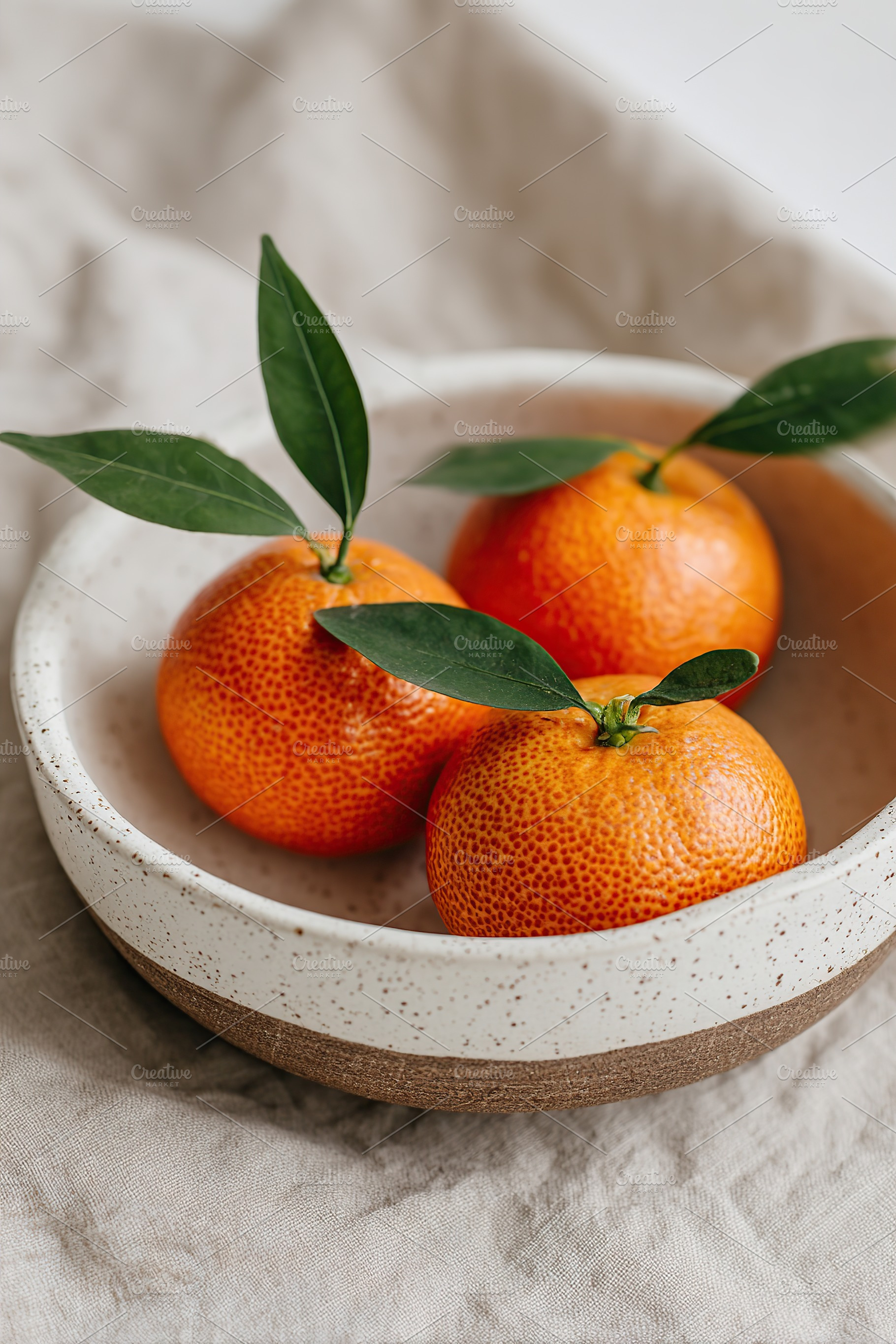 Handcrafted ceramic bowl holds fresh, bright oranges with leaves resting elegan, a Food & Drink Photo by AlyaAnd