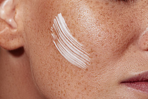 Freckled female skin with a cream, a Person Photo by Artem Varnitsin