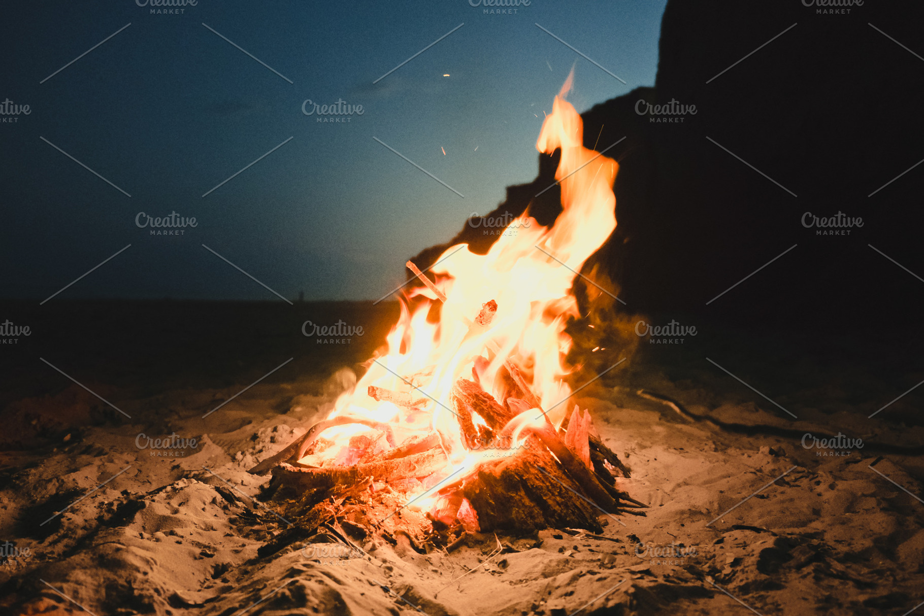 Fire burning on the beach featuring beach, nature, and people, a Holiday Photo by Pro.Motion