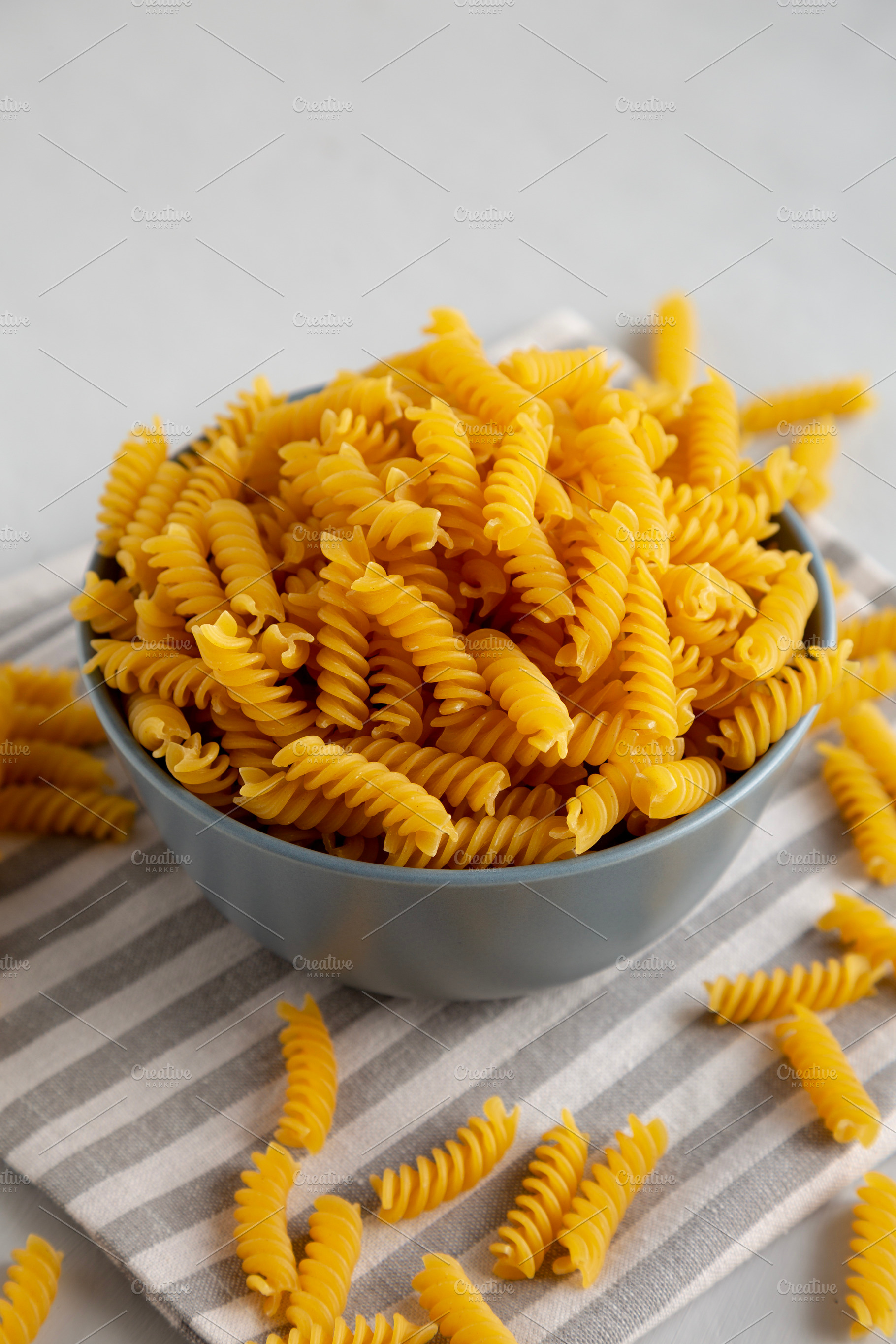 Dry Fusilli Pasta in a Bowl, side view. Close-up., a Food & Drink Photo by LiudmylaChuhunova