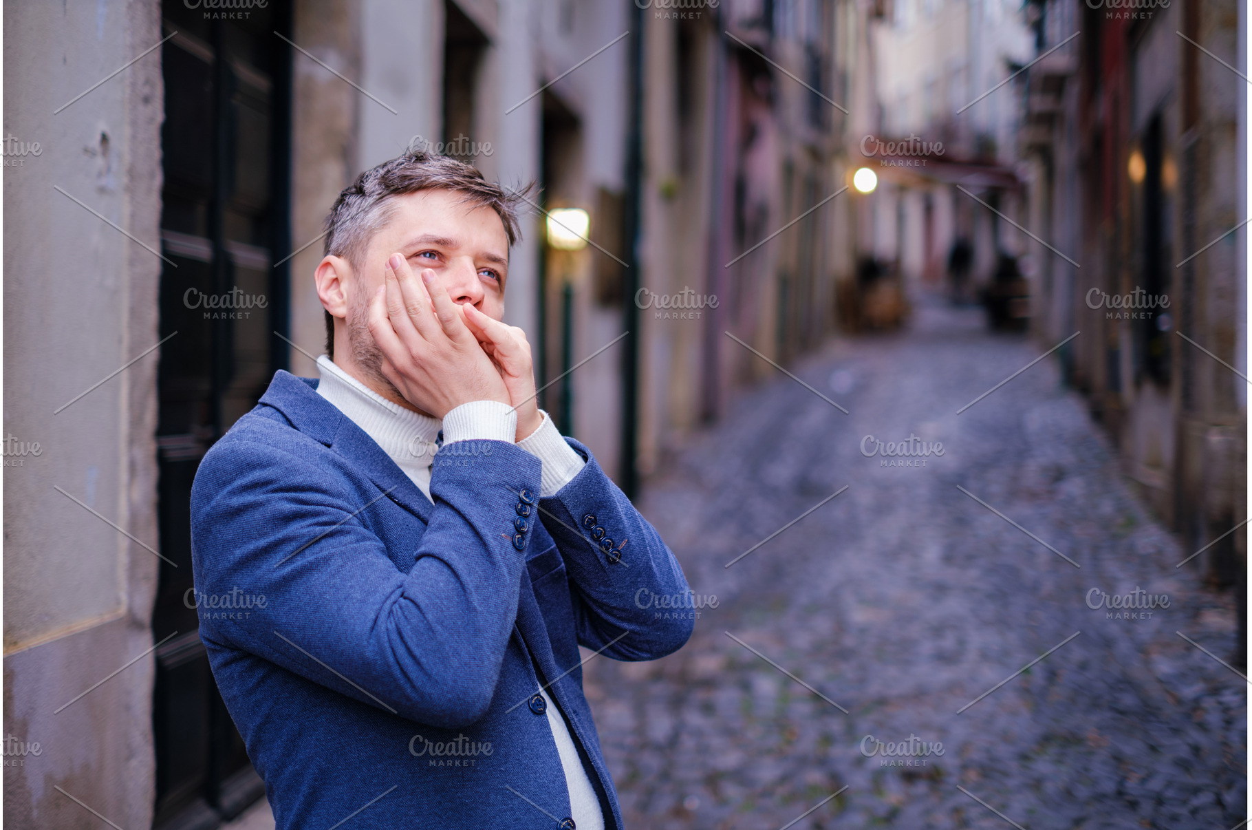 Man plays harmonica outdoors in city, a Person Photo by f9photos
