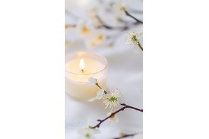 Lit candle and white blossoms on, a Beauty & Fashion Photo by Lermont51