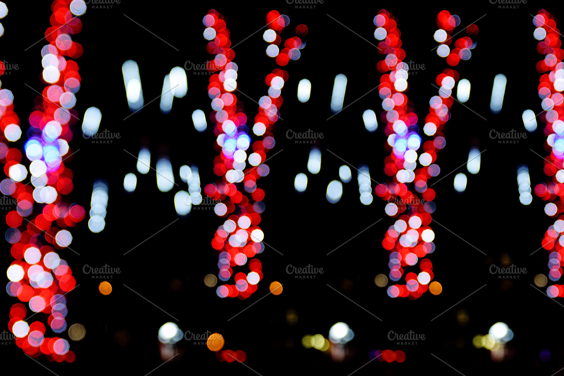 Vertical stripes of red and white bokeh lights on black backgrou, a Background Photo by ndanko