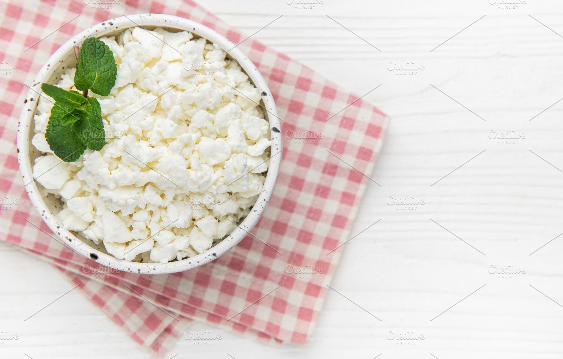 Cottage cheese in bowl with mint leaves, a Food & Drink Photo by Olena Rudo