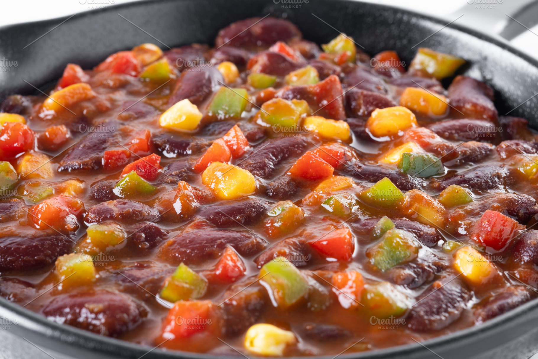 Mexican chilli beans with vegetables in iron pan, a Food & Drink Photo by etorres69