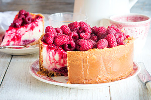 Vanilla cheese cake containing table, plate, and delicious