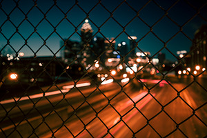 City skyline through the wire mesh containing abstract, architecture, and