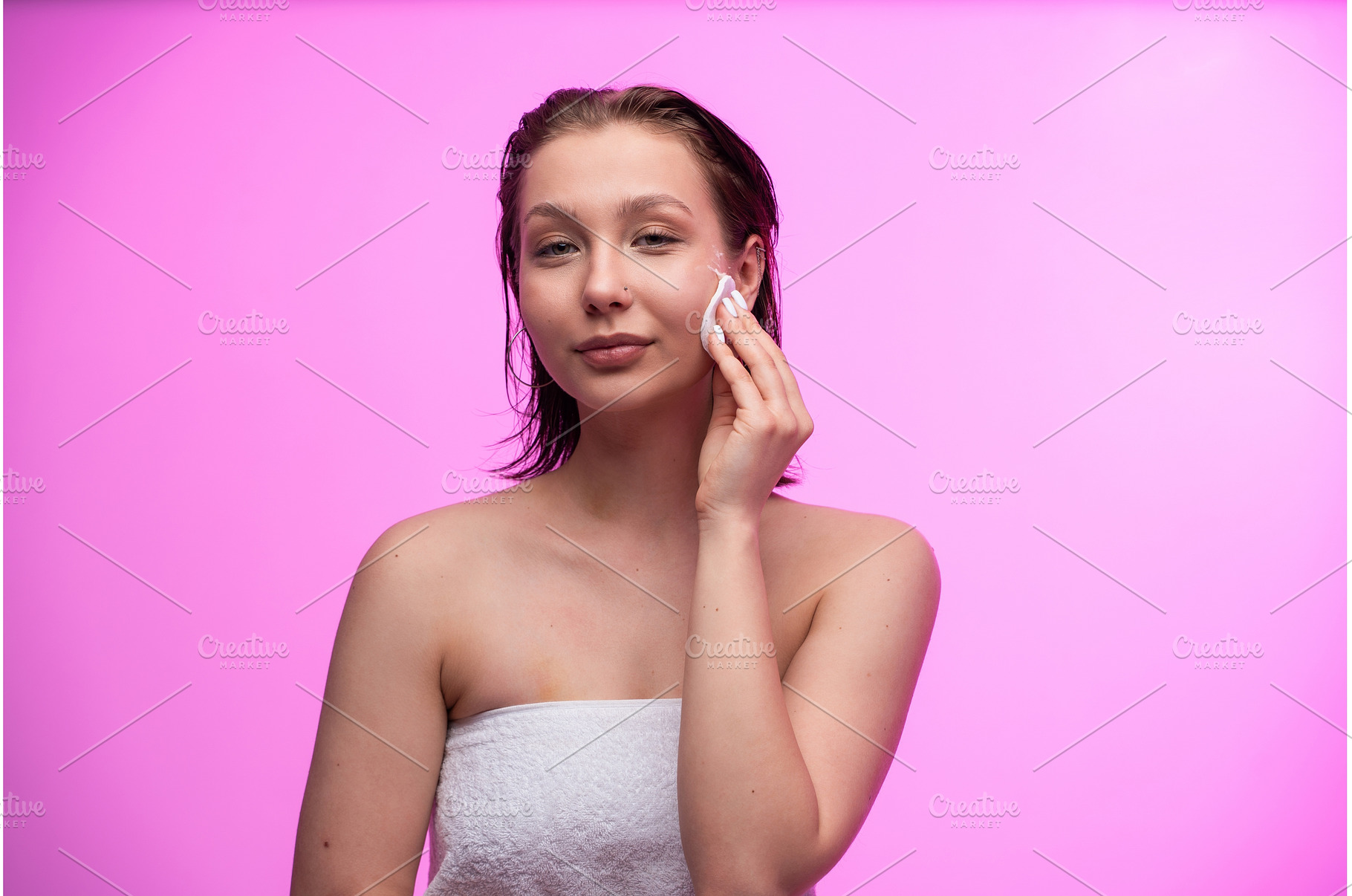 Woman gently wiping her cheek with a, a Person Photo by volodymyrshtun13795