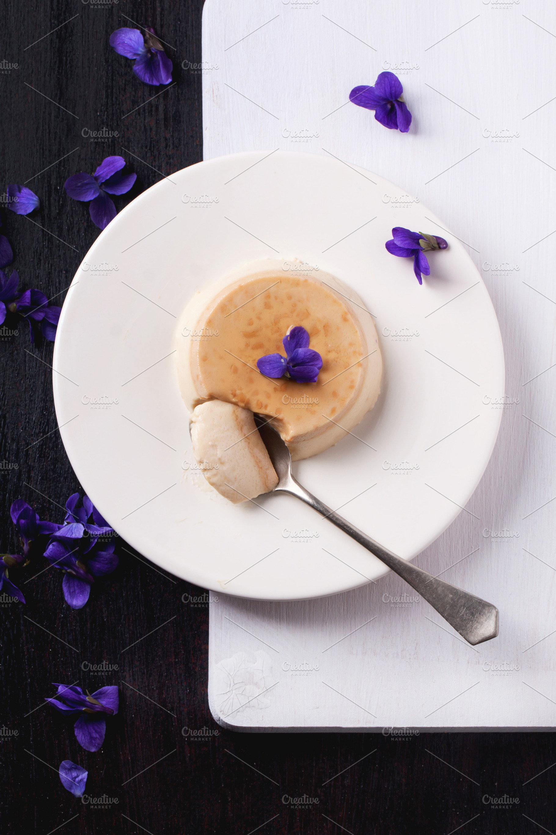 Caramel pannacotta with violet flowers containing panna, cotta, and pannacotta