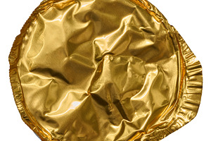 Wrinkled, round, golden foil lid, isolated background, viewed fr, an Industrial Photo by ndanko