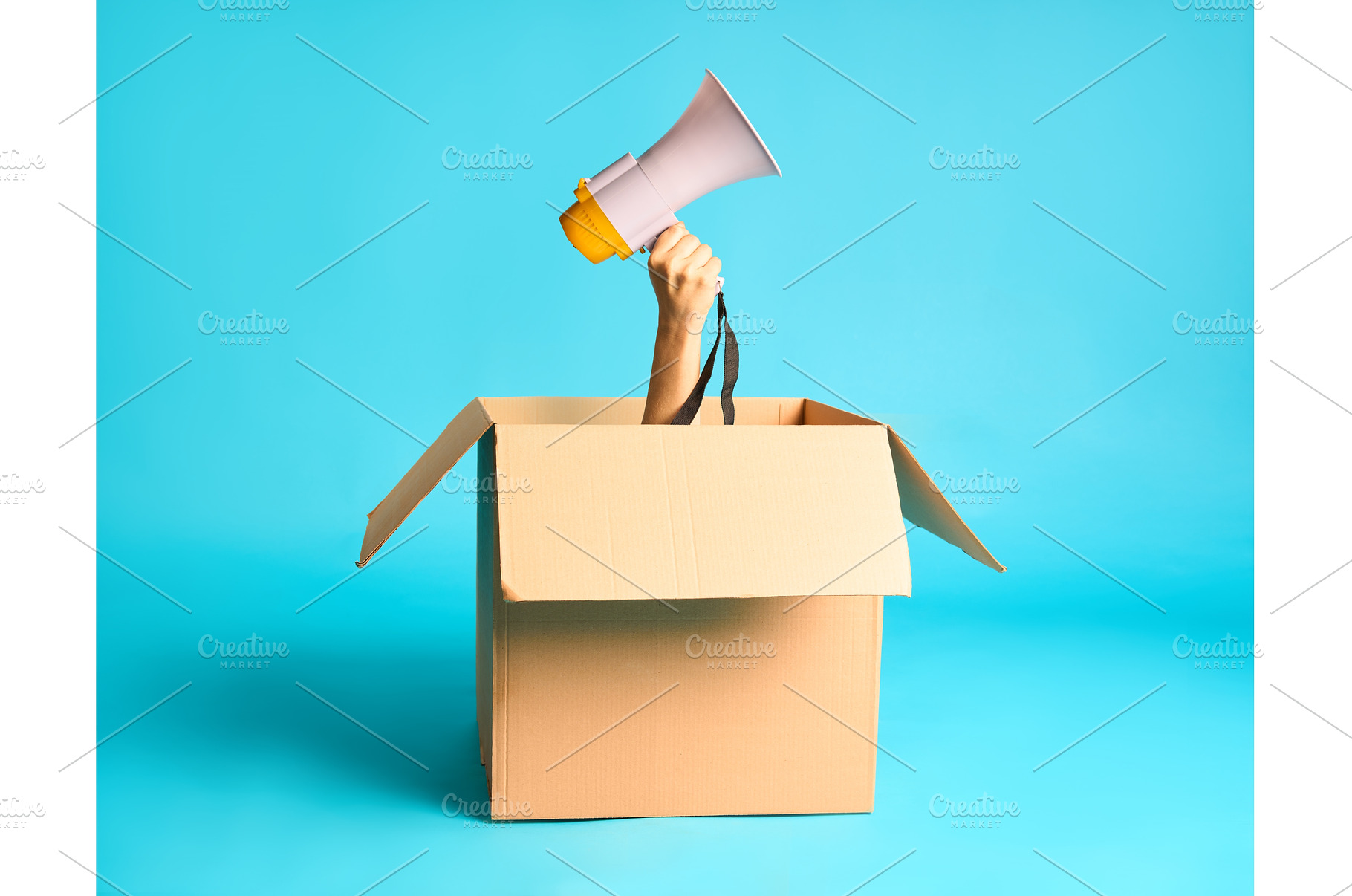 Hand with megaphone raised from, a Business Photo by Gladkov photography