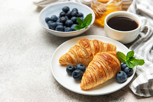 Delicious french breakfast with croissants, coffee, honey and fr, a Food & Drink Photo by Olena Rudo