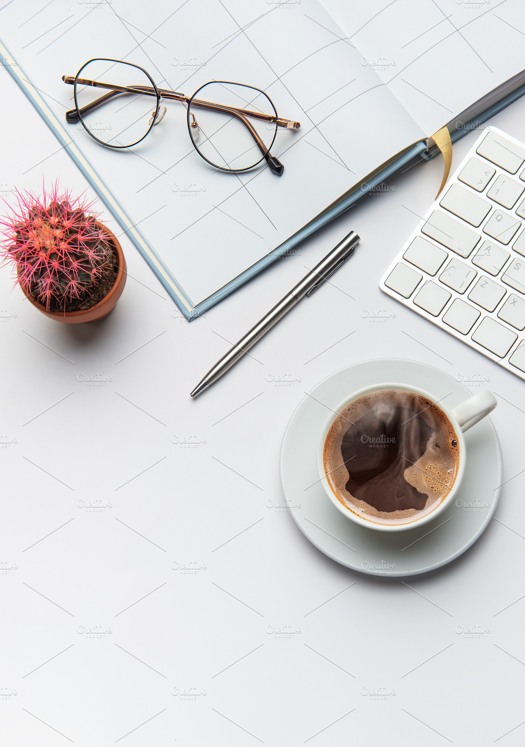 Office worker desk with coffee, cactus, pen, eyeglasses, and key, a Business Photo by Olena Rudo