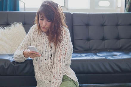 Woman using her smartphone containing adult, adults only, and beautiful people, a Person Photo by 2Design