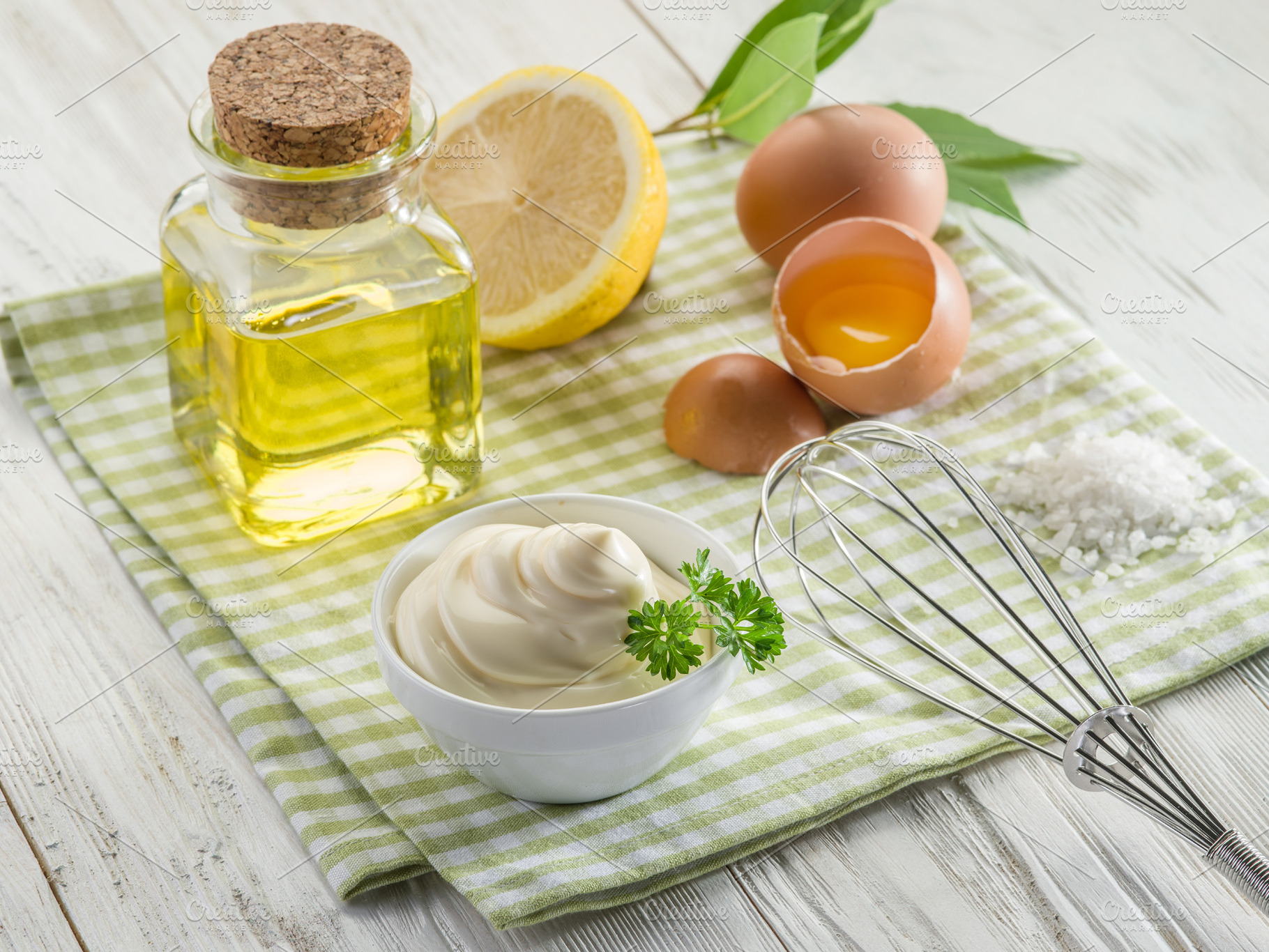 Bowl with mayonnaise sauce in the centre and mayonnaise ingredie, a Food & Drink Photo by Volff