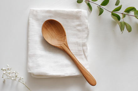 Wooden spoon on white napkin, a Food & Drink Photo by Virgo Studio
