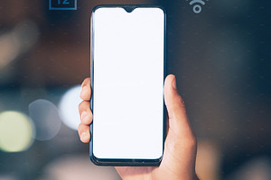 Hands, phone and mockup screen with icons at night for networking, social media or communication at the office. Hand of employee showing smartphone display for mobile app, branding or multimedia, a Photo by Peopleimages.com