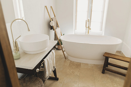 Stylish boho bathroom design. Modern bathtub with golden faucet, an Architecture Photo by Sonjachni