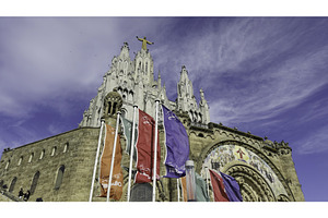 Colorful flags waving at tibidabo, an Architecture Photo by Media Whale Stock