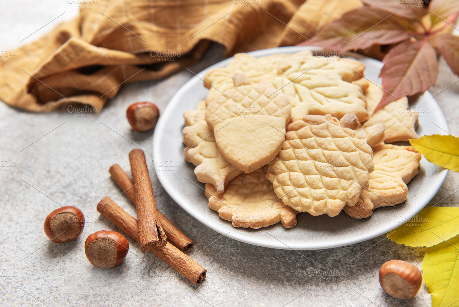 Autumn cookies on plate with cinnamon and hazelnuts, a Food & Drink Photo by Olena Rudo