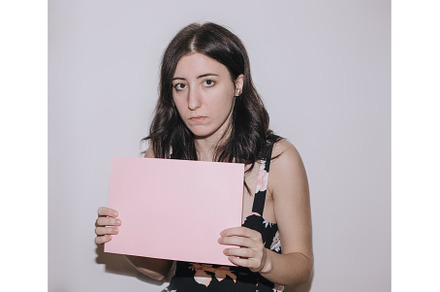 Sad young woman holding a blank, a Person Photo by zheckasmk
