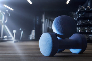 Sport training with dumbbell on wooden floor and gym background, a Sports & Recreation Photo by Davizro's Market