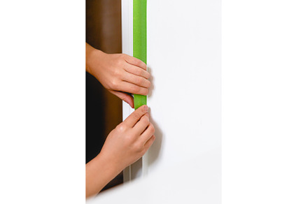 Applaying masking tape to the wall, an Architecture Photo by MAnuta